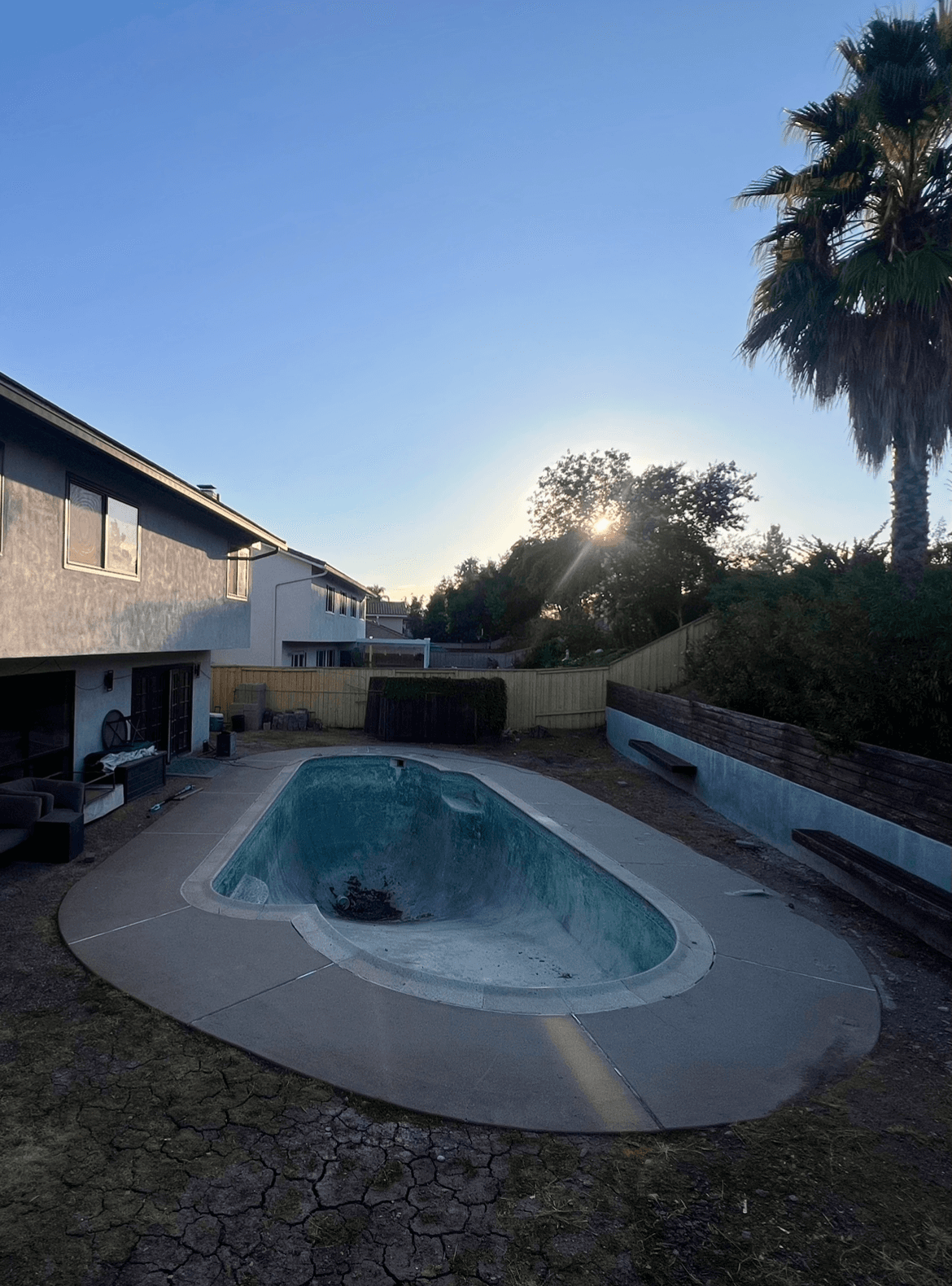 The real backyard and old empty pool before construction